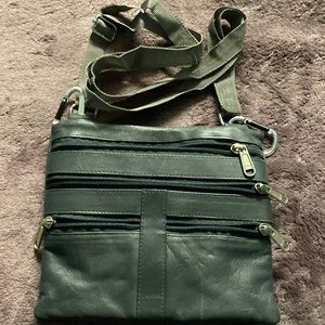Small cross body bag. Can attach to belt loops or use with strap. Never used